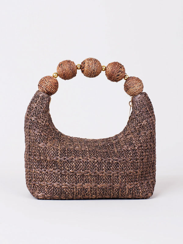 Woven bag with oversized bead handle
